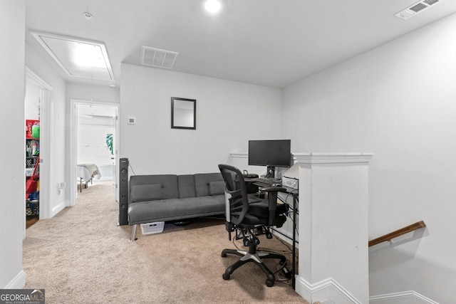 home office featuring baseboards, carpet flooring, visible vents, and attic access