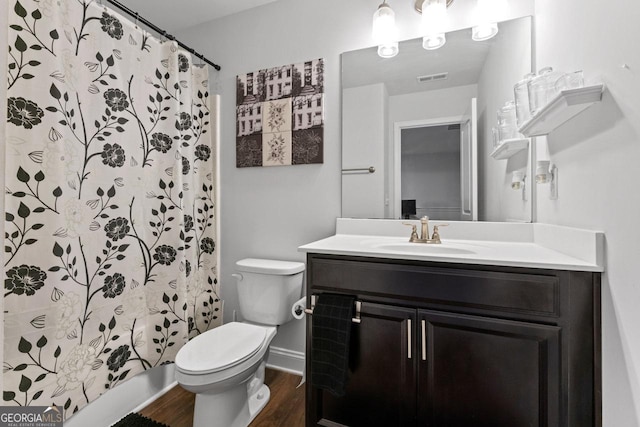 full bathroom featuring vanity, toilet, baseboards, visible vents, and wood finished floors