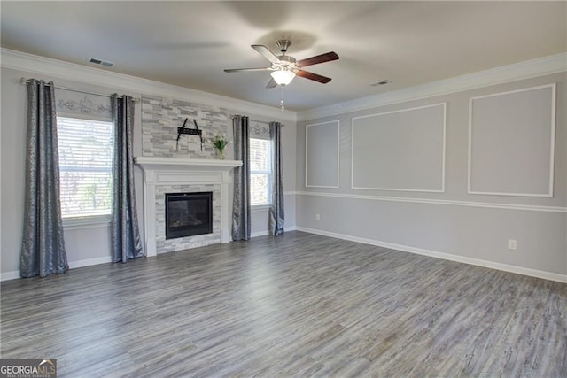 190 Crown Pointe Dr, Dawsonville, GA 30534 - unfurnished living room featuring ceiling fan, wood finished floors, baseboards, crown molding, and a stone fireplace