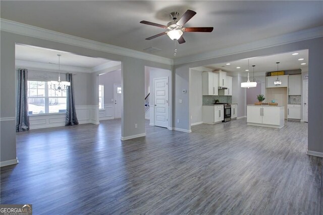 190 Crown Pointe Dr, Dawsonville, GA 30534 - unfurnished living room featuring a chandelier, ceiling fan, ornamental molding, dark wood-type flooring, and baseboards