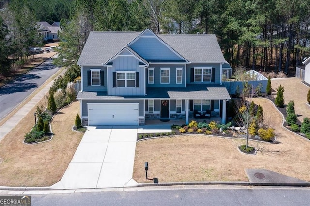 190 Crown Pointe Dr, Dawsonville, GA 30534 - craftsman-style house with board and batten siding, driveway, a porch, an attached garage, and roof with shingles