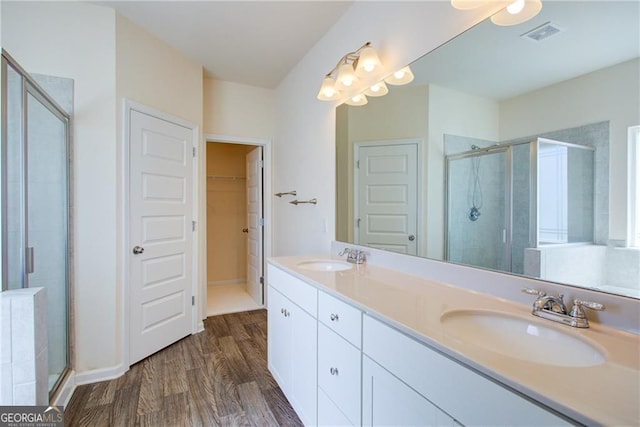 190 Crown Pointe Dr, Dawsonville, GA 30534 - bathroom featuring a stall shower, wood finished floors, double vanity, and a spacious closet