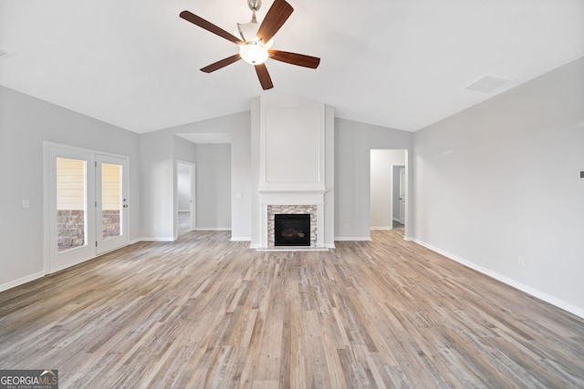 unfurnished living room featuring visible vents, baseboards, a ceiling fan, light wood-type flooring, and vaulted ceiling