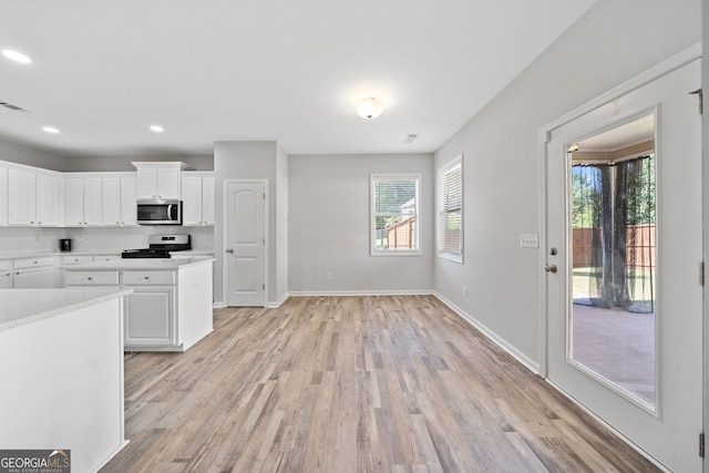 kitchen featuring light countertops, appliances with stainless steel finishes, and light wood-style flooring