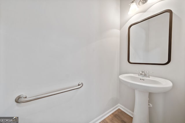 bathroom with baseboards and wood finished floors
