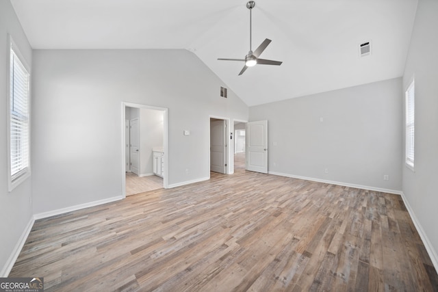 unfurnished bedroom with baseboards, visible vents, multiple windows, and light wood-type flooring