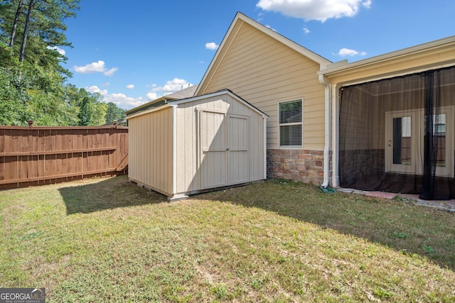 view of shed featuring fence