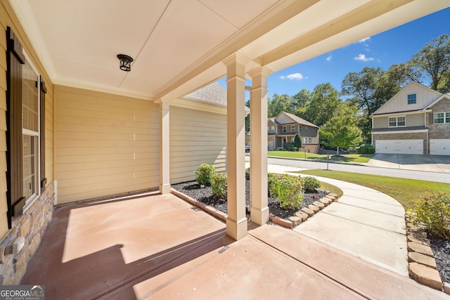 view of patio / terrace with a residential view and covered porch
