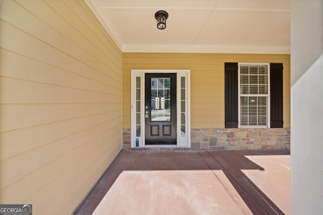 property entrance featuring stone siding and a porch