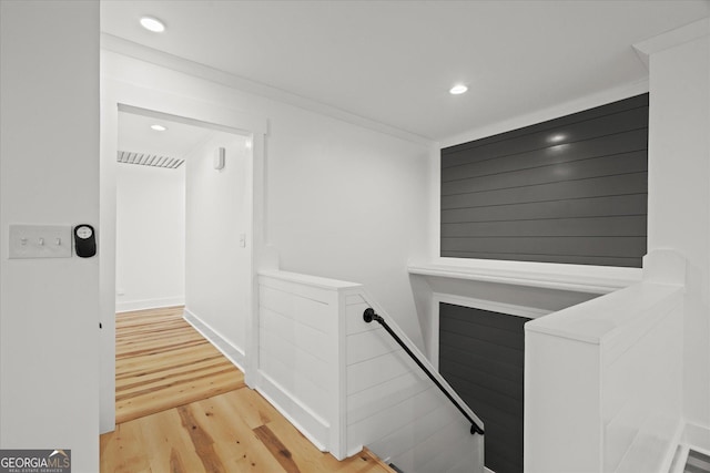 stairs with visible vents, recessed lighting, and wood finished floors