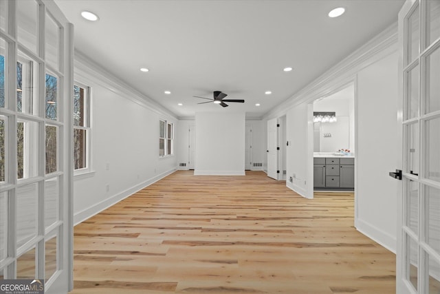 unfurnished living room with crown molding, baseboards, a ceiling fan, and recessed lighting