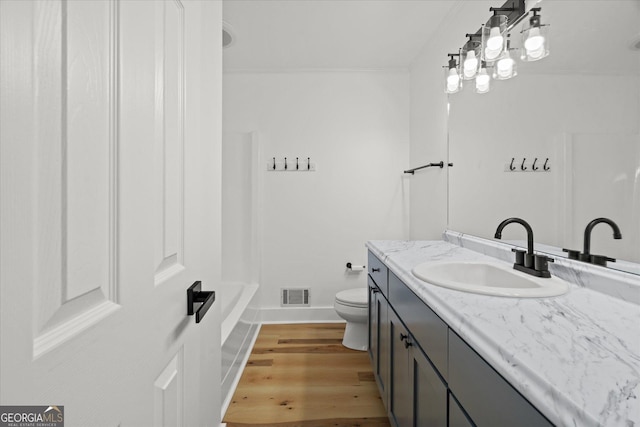 full bathroom featuring vanity, baseboards, toilet, visible vents, and wood finished floors