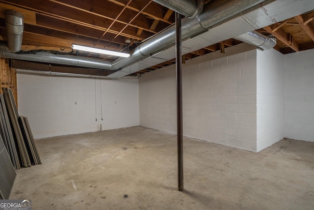 unfinished basement with concrete block wall