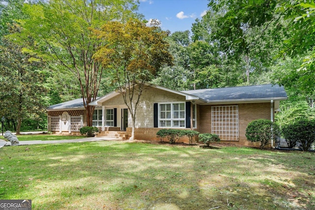 view of front of home featuring a front yard and brick siding