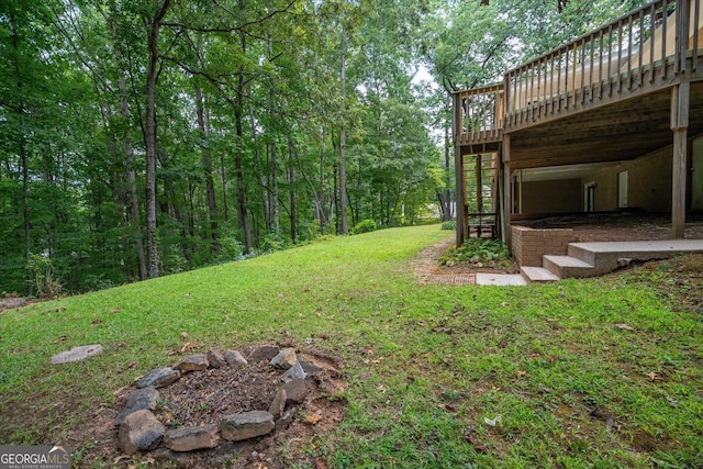 view of yard featuring a deck and stairs