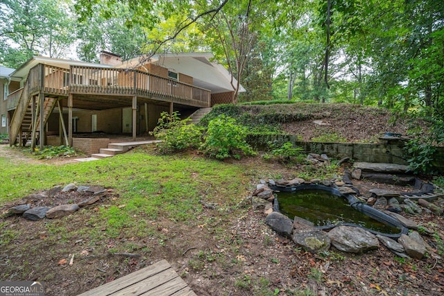 view of yard featuring a wooden deck and stairway