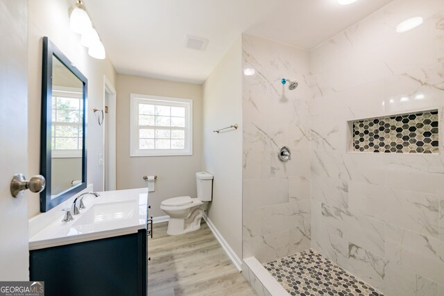 54 Jean Ct, Hiram, GA 30141 - bathroom with toilet, tiled shower, vanity, wood finished floors, and baseboards