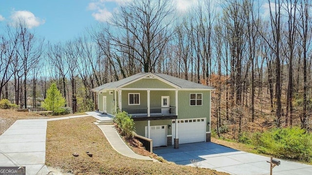4660 Perry Rd, Gainesville, GA 30506 - view of front of house with an attached garage, stone siding, a forest view, and driveway