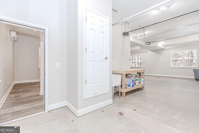 4660 Perry Rd, Gainesville, GA 30506 - garage featuring baseboards and an AC wall unit