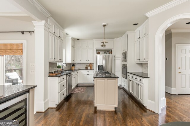 275 Tynebrae Pl, Roswell, GA 30075 - kitchen featuring a sink, wine cooler, appliances with stainless steel finishes, decorative backsplash, and dark wood-style floors