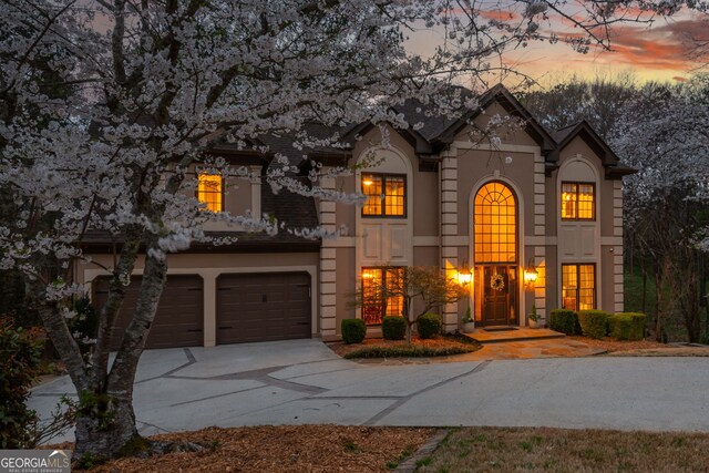 275 Tynebrae Pl, Roswell, GA 30075 - view of front of house featuring a garage, stucco siding, and driveway