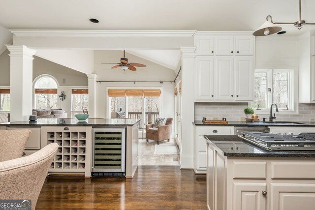 275 Tynebrae Pl, Roswell, GA 30075 - kitchen featuring a breakfast bar area, a center island, dark wood-style flooring, open shelves, and dark stone counters