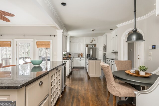 275 Tynebrae Pl, Roswell, GA 30075 - kitchen featuring wine cooler, ornamental molding, dark wood finished floors, decorative backsplash, and a kitchen island