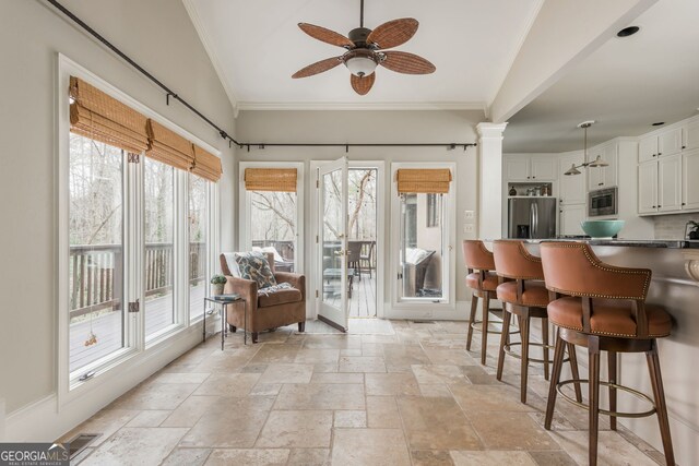 275 Tynebrae Pl, Roswell, GA 30075 - interior space featuring a ceiling fan, a breakfast bar area, decorative columns, stainless steel microwave, and white cabinets