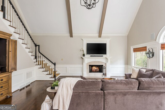 275 Tynebrae Pl, Roswell, GA 30075 - living area featuring a warm lit fireplace, stairs, high vaulted ceiling, wood finished floors, and beam ceiling