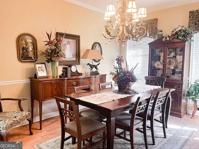 198 Oakdale Rd SE, Cairo, GA 39828 - dining room with light wood-style flooring, ornamental molding, and a notable chandelier