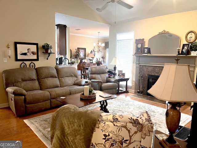 198 Oakdale Rd SE, Cairo, GA 39828 - living area with lofted ceiling, ceiling fan with notable chandelier, baseboards, a fireplace, and wood finished floors