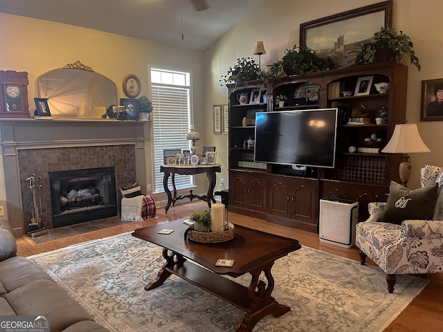 198 Oakdale Rd SE, Cairo, GA 39828 - living room with ceiling fan, wood finished floors, vaulted ceiling, and a tile fireplace