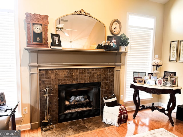 198 Oakdale Rd SE, Cairo, GA 39828 - interior details with baseboards, visible vents, a tile fireplace, and wood finished floors