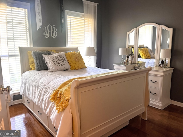 198 Oakdale Rd SE, Cairo, GA 39828 - bedroom featuring baseboards and dark wood-style floors