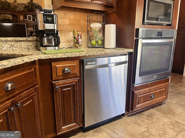 198 Oakdale Rd SE, Cairo, GA 39828 - kitchen featuring light stone counters, backsplash, and stainless steel appliances