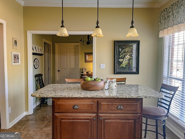 198 Oakdale Rd SE, Cairo, GA 39828 - kitchen featuring decorative light fixtures, a breakfast bar area, crown molding, and a center island