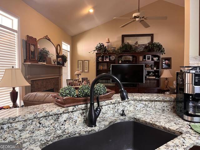 198 Oakdale Rd SE, Cairo, GA 39828 - living room featuring vaulted ceiling, a fireplace, and a healthy amount of sunlight