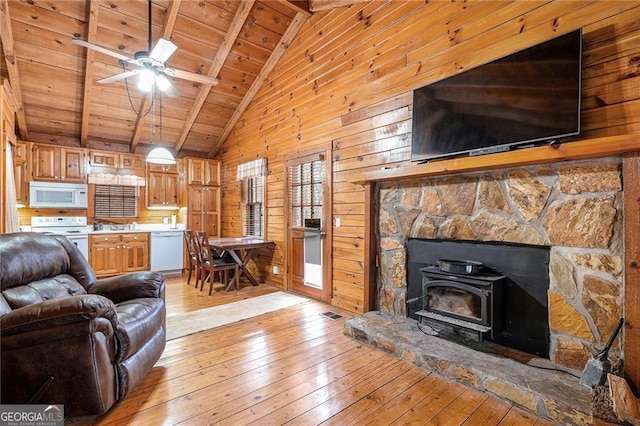 335 Misty Hollow Rd, Ellijay, GA 30536 - living room featuring wooden ceiling, light wood-type flooring, beam ceiling, wood walls, and ceiling fan