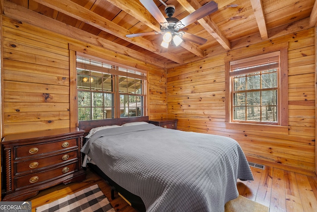 335 Misty Hollow Rd, Ellijay, GA 30536 - bedroom featuring wood ceiling, beam ceiling, wood walls, hardwood / wood-style flooring, and a ceiling fan
