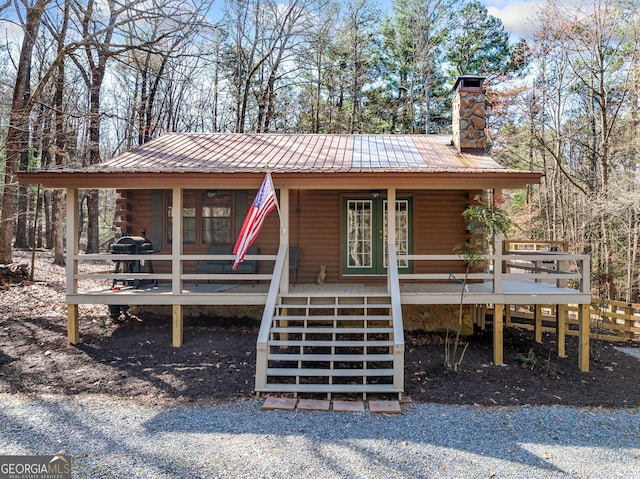 335 Misty Hollow Rd, Ellijay, GA 30536 - view of front of house with a chimney, covered porch, log exterior, and metal roof