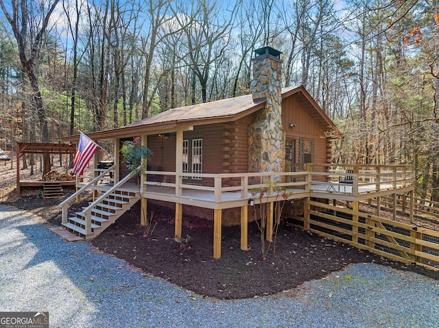 335 Misty Hollow Rd, Ellijay, GA 30536 - view of front facade featuring log siding, a deck, a chimney, and metal roof