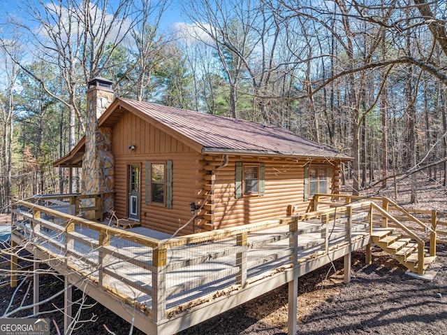 335 Misty Hollow Rd, Ellijay, GA 30536 - view of home's exterior with log exterior, a wooden deck, a chimney, and metal roof