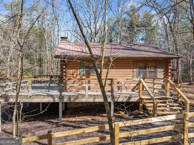 335 Misty Hollow Rd, Ellijay, GA 30536 - view of home's exterior with log exterior, metal roof, a chimney, and a wooden deck