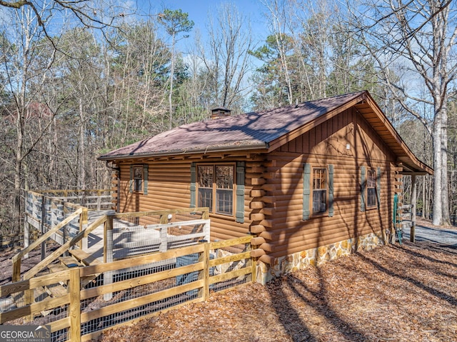 335 Misty Hollow Rd, Ellijay, GA 30536 - view of front facade featuring log siding, a wooden deck, and a chimney