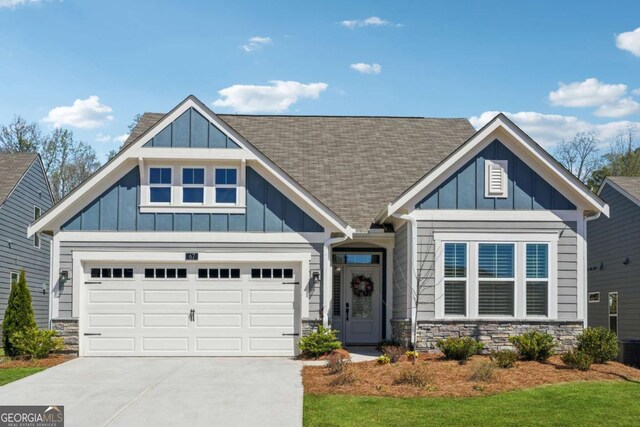 67 Narrowleaf Ln, Dallas, GA 30157 - craftsman-style home with stone siding, board and batten siding, concrete driveway, and roof with shingles