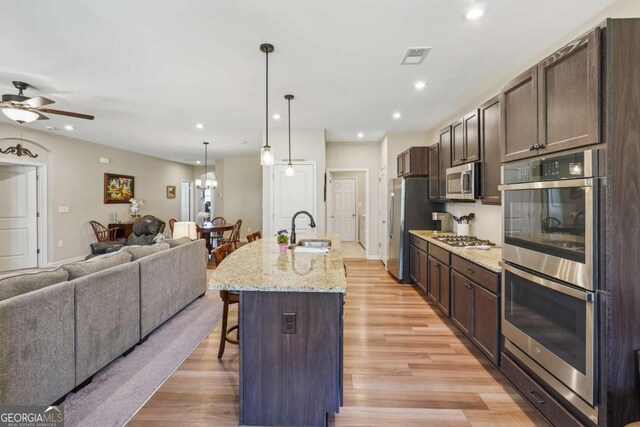 67 Narrowleaf Ln, Dallas, GA 30157 - kitchen featuring a sink, a ceiling fan, a kitchen bar, open floor plan, and stainless steel appliances