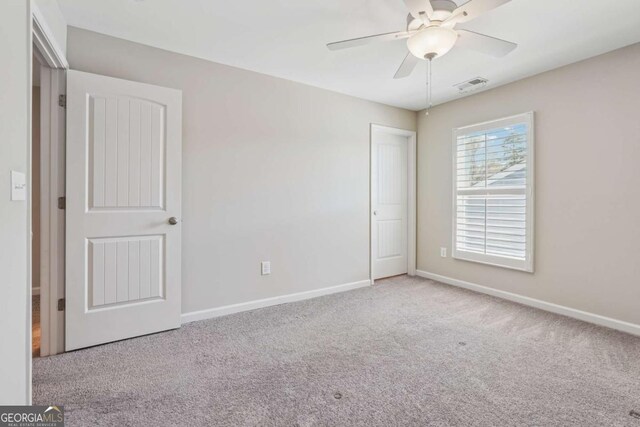 67 Narrowleaf Ln, Dallas, GA 30157 - unfurnished bedroom with baseboards, carpet floors, ceiling fan, and visible vents