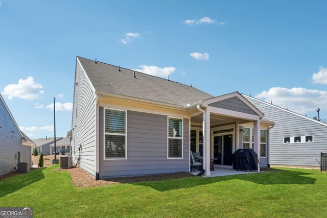 67 Narrowleaf Ln, Dallas, GA 30157 - back of house featuring central air condition unit, a lawn, and a patio