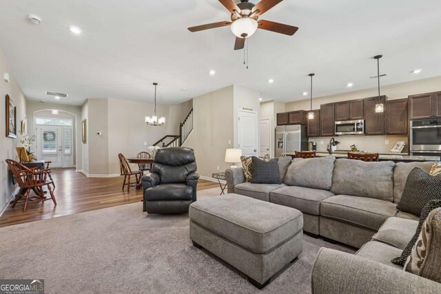 67 Narrowleaf Ln, Dallas, GA 30157 - living area featuring baseboards, recessed lighting, arched walkways, light wood-type flooring, and ceiling fan with notable chandelier