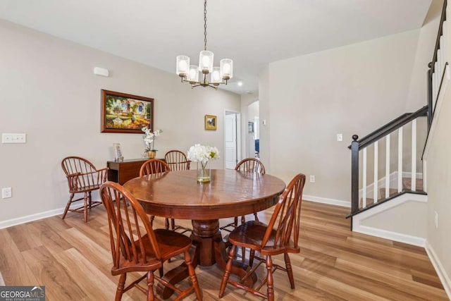 67 Narrowleaf Ln, Dallas, GA 30157 - dining space featuring baseboards, light wood-style flooring, and an inviting chandelier